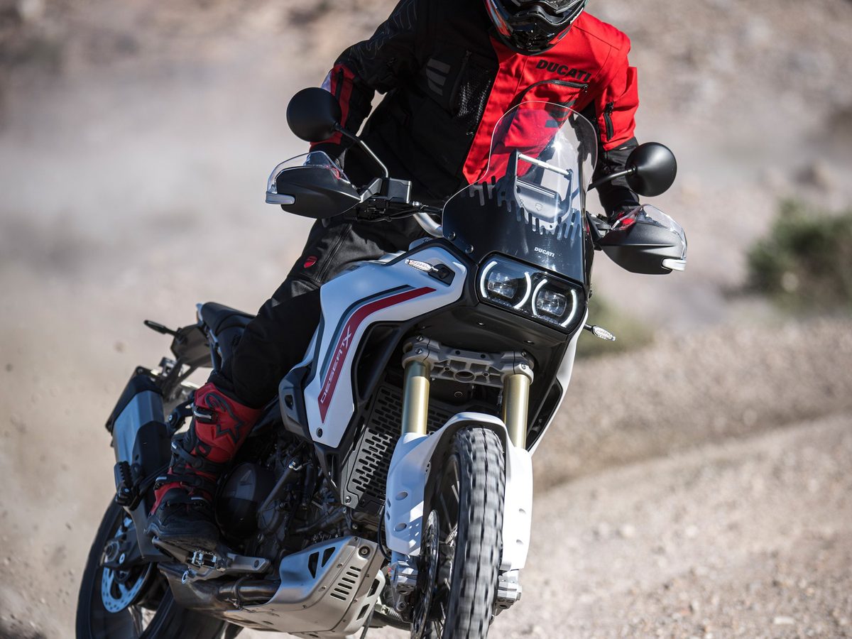 Ducati DesertX בנסיעה על מצע חצץ ואבק